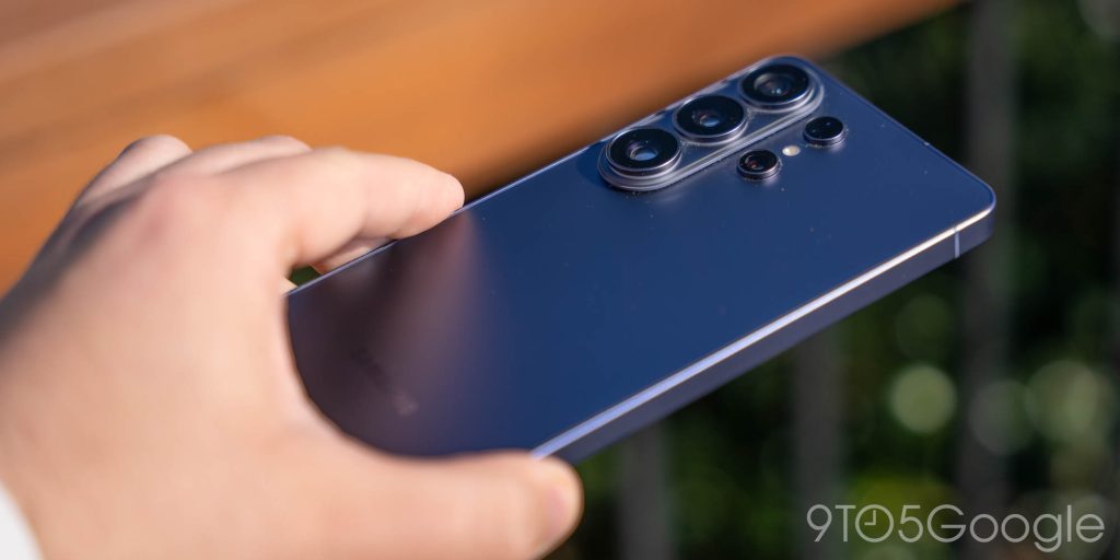 The Galaxy S26 Ultra sitting on a wooden surface, showing its sleek industrial design.