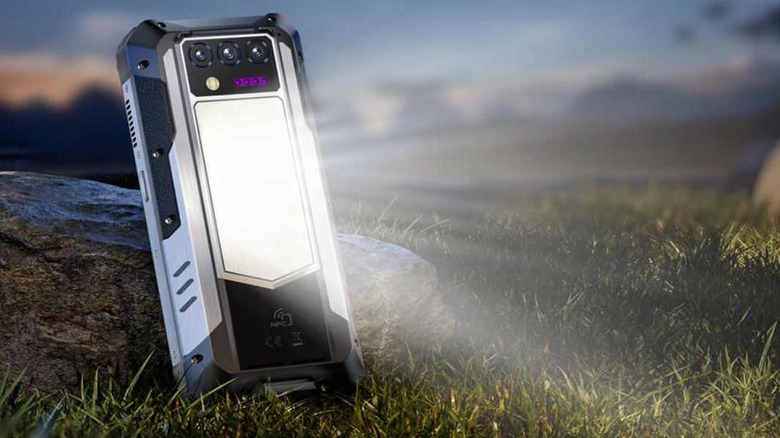 The Oukitel WP100 Titan smartphone with its integrated camping light feature turned on.