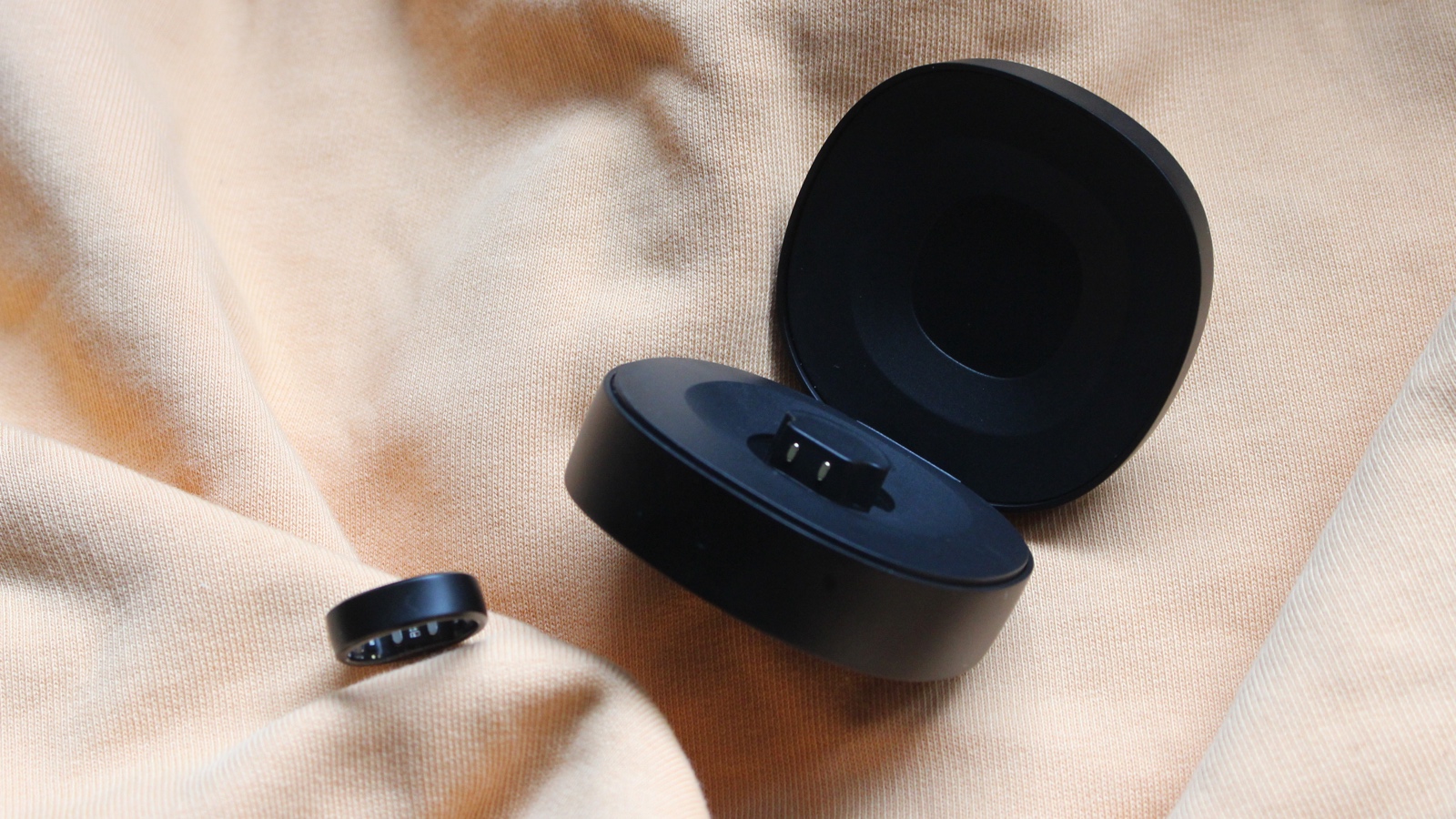 Close-up of the RingConn Gen 2 resting inside its dedicated portable charging case.