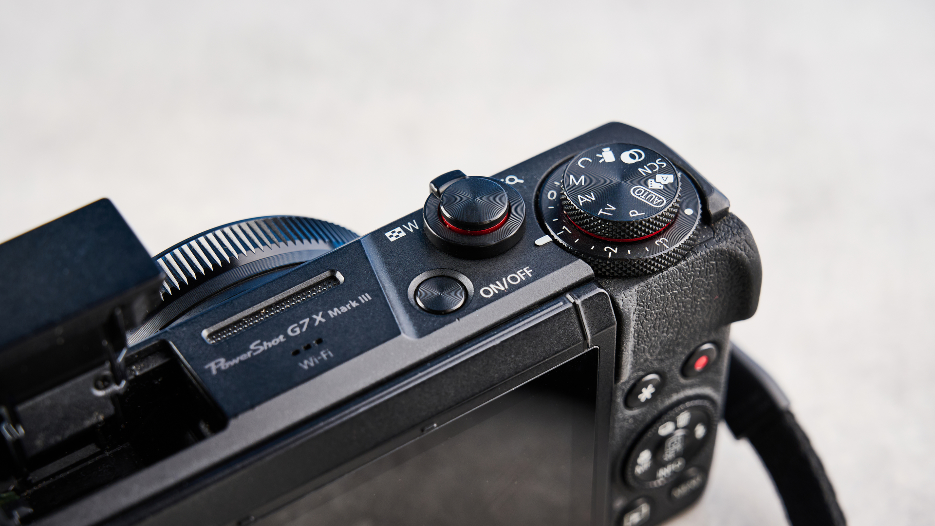 Top-down view of the exposure compensation and mode dials on the PowerShot G7 X Mark III.