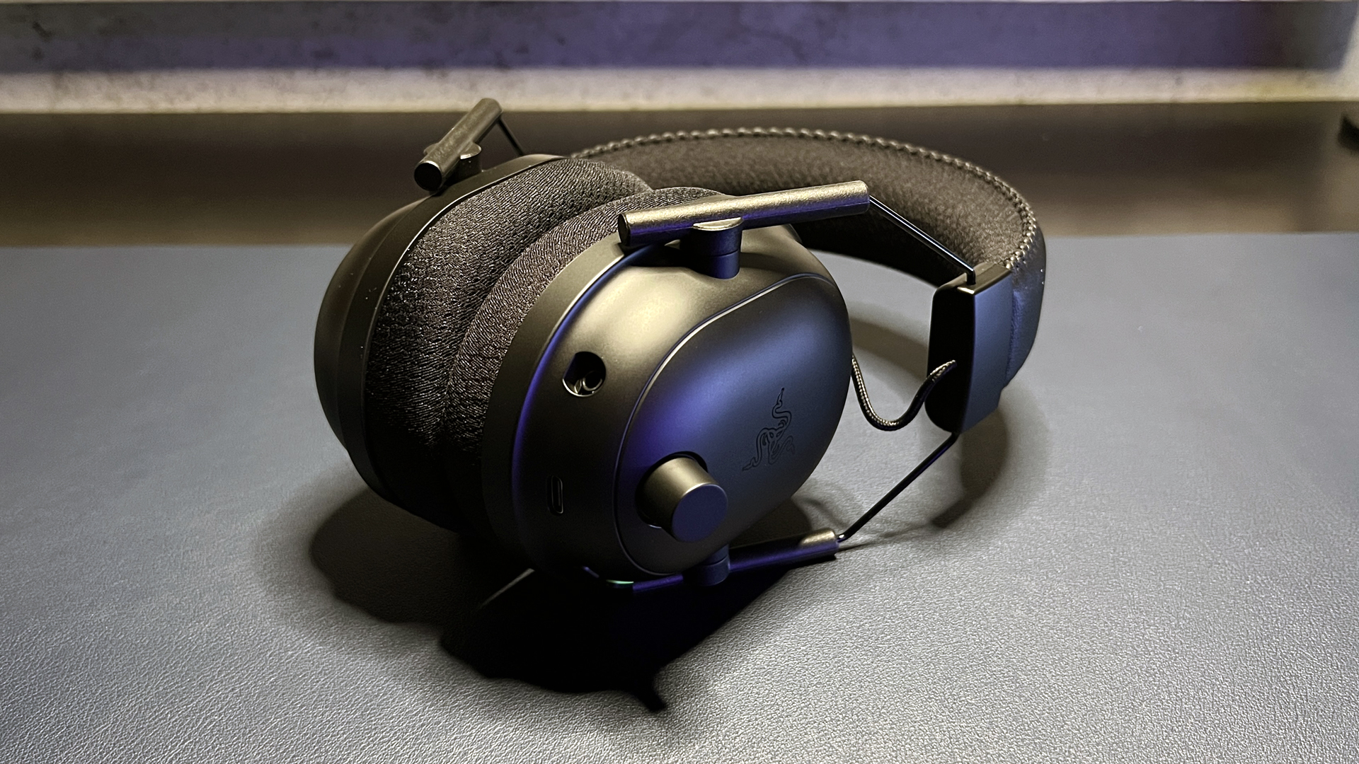 Close-up view of the textured volume control knob on a Razer headset.