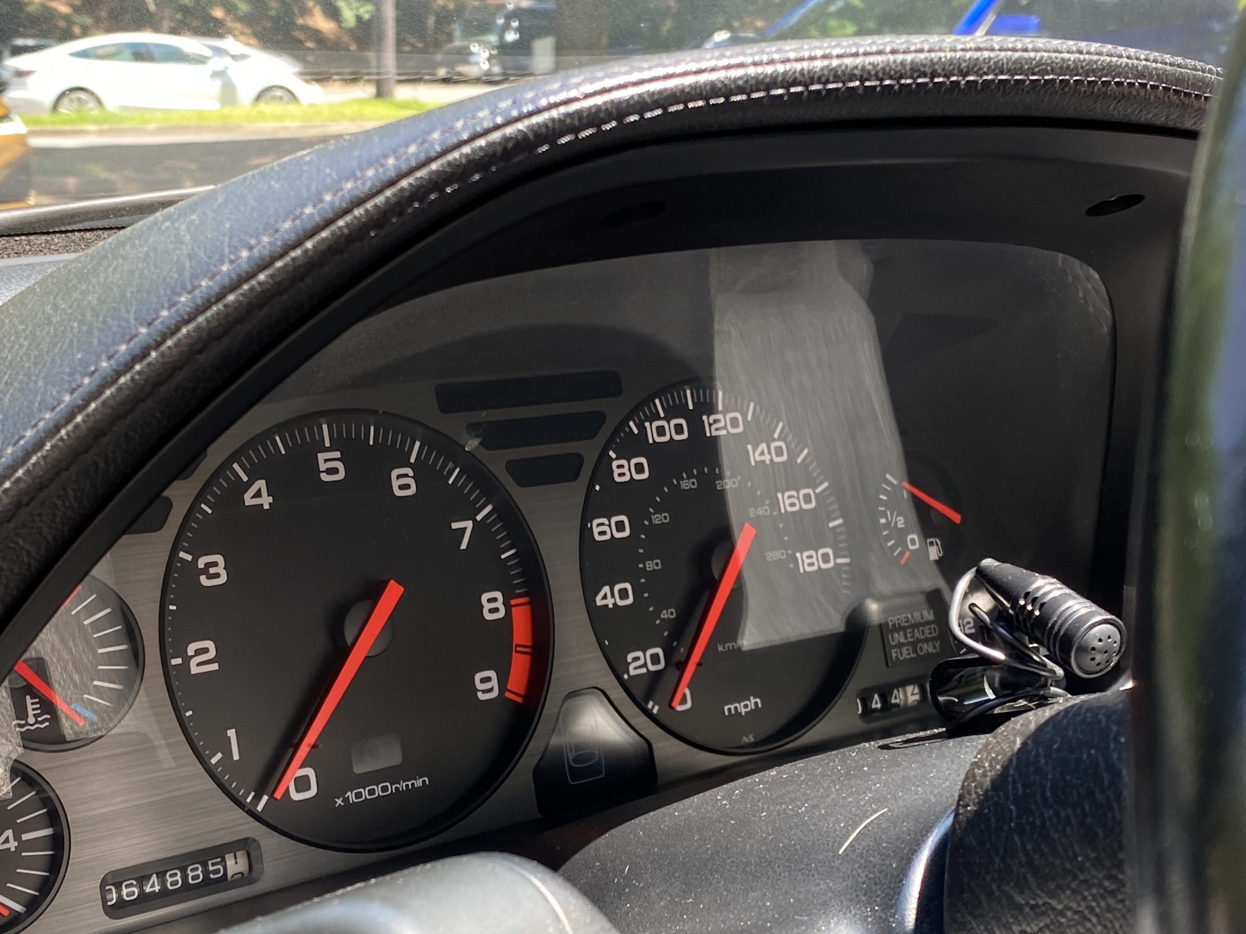 Rear view of a silver Acura NSX highlighting the signature full-width integrated rear wing and taillights.