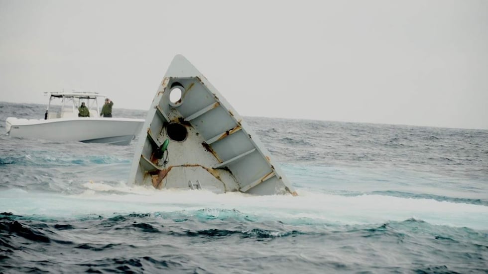 The Navy torpedo retriever HAZAR being scuttled in the ocean to serve as an artificial reef.