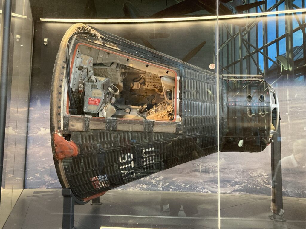 The Gemini IV spacecraft on display in a museum gallery.