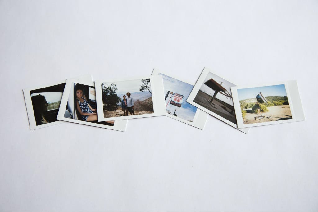 A collection of instant film photos showing various road trip highlights