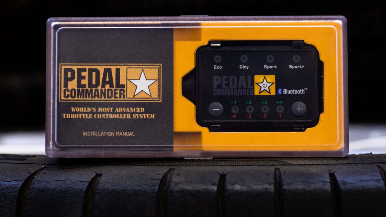 A Pedal Commander throttle response controller device shown in detail.