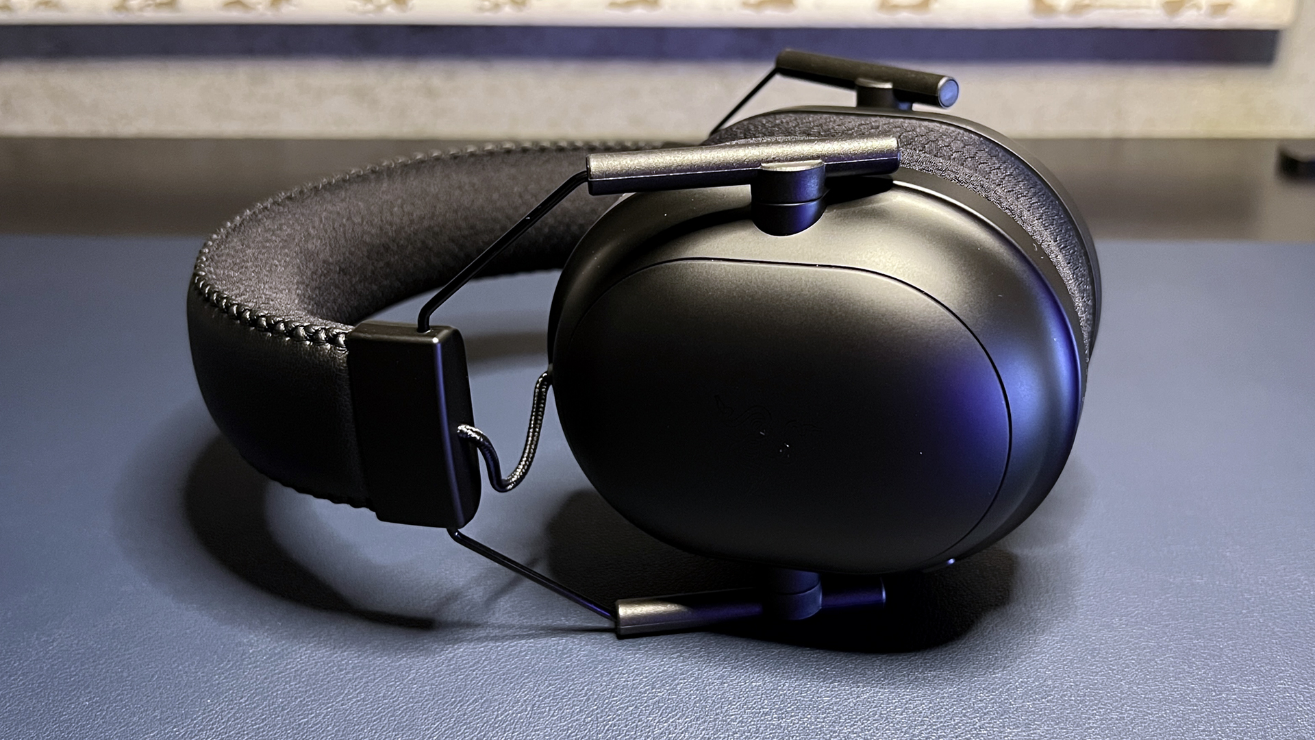 Razer BlackShark V2 Pro gaming headset resting on a desk.