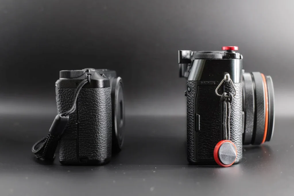 Side-by-side size comparison of two compact digital cameras.