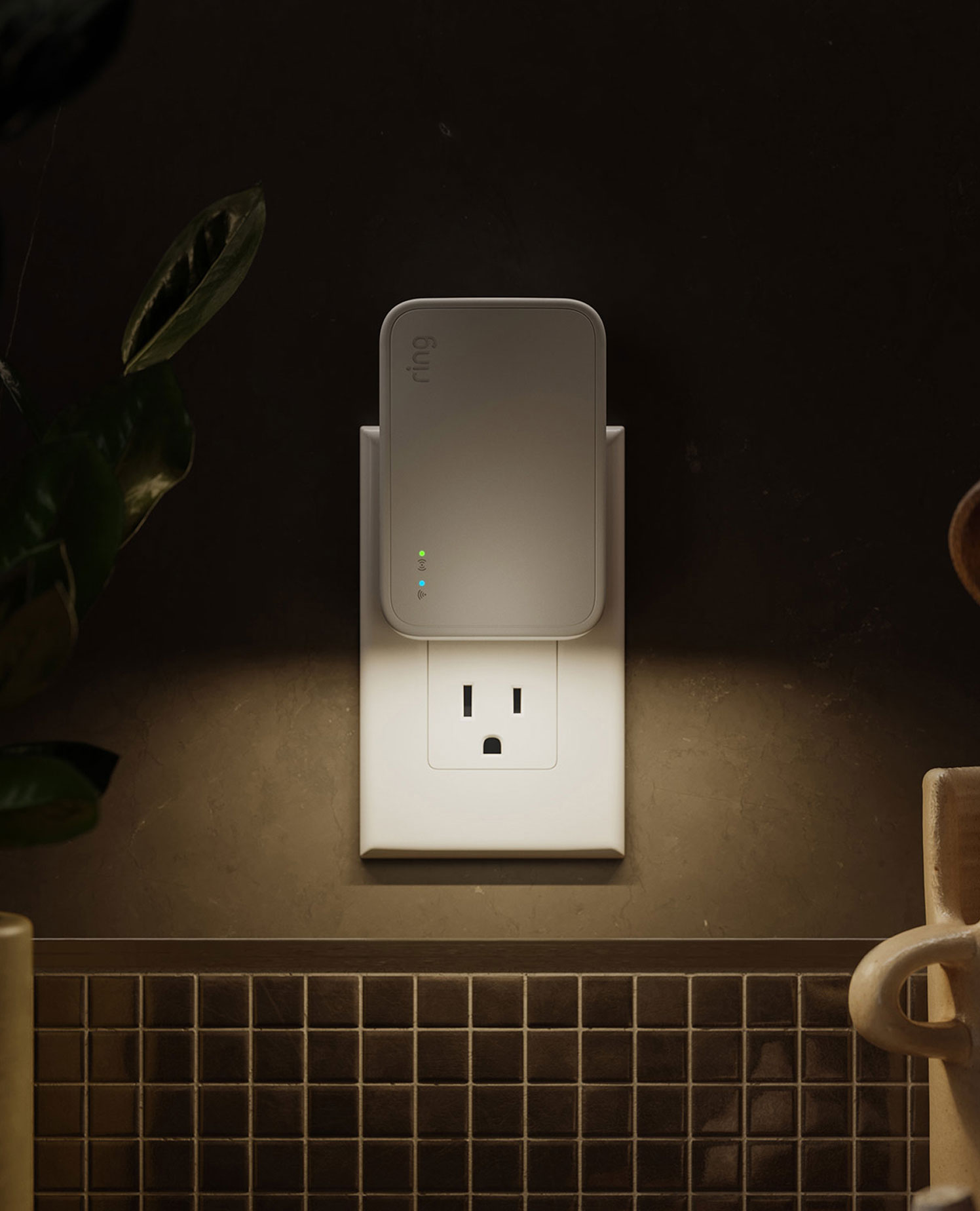 The Ring Bridge plugged into a standard wall outlet in a kitchen setting.