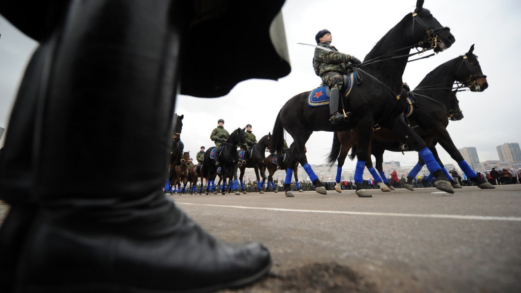 A Russian soldier on horseback navigating a battlefield environment.