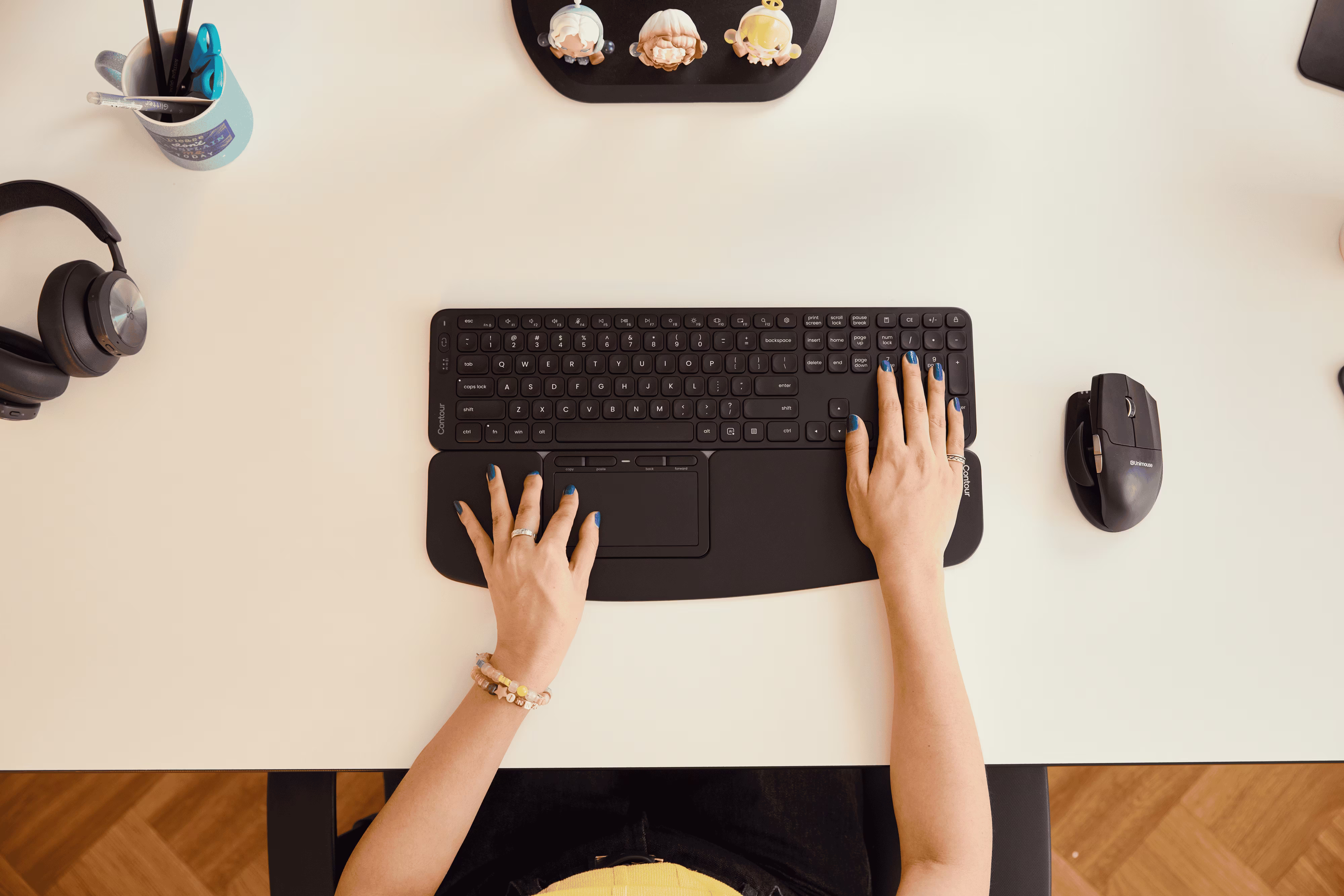 A close-up of hands on a keyboard showing wrists in a flat, neutral position.