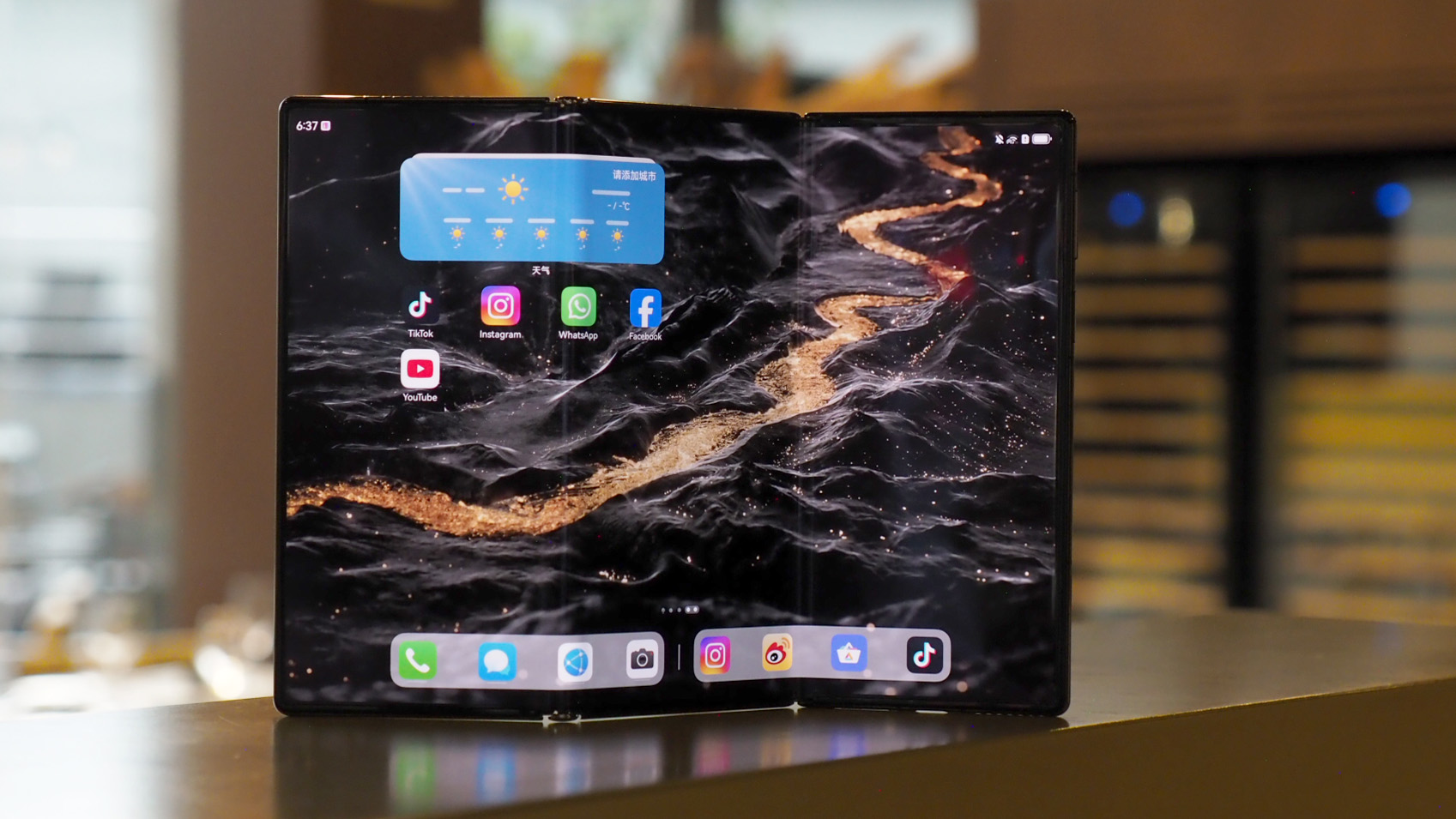 Huawei Mate XT triple-folding phone shown in its fully expanded tablet mode.