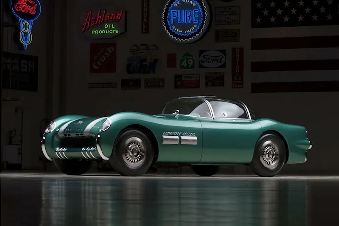 Side profile of the white 1953 Corvette body, highlighting the flowing lines and chrome trim.