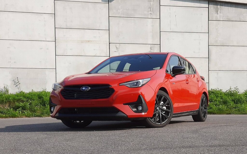 A 2026 Subaru Impreza hatchback driving on an open road.
