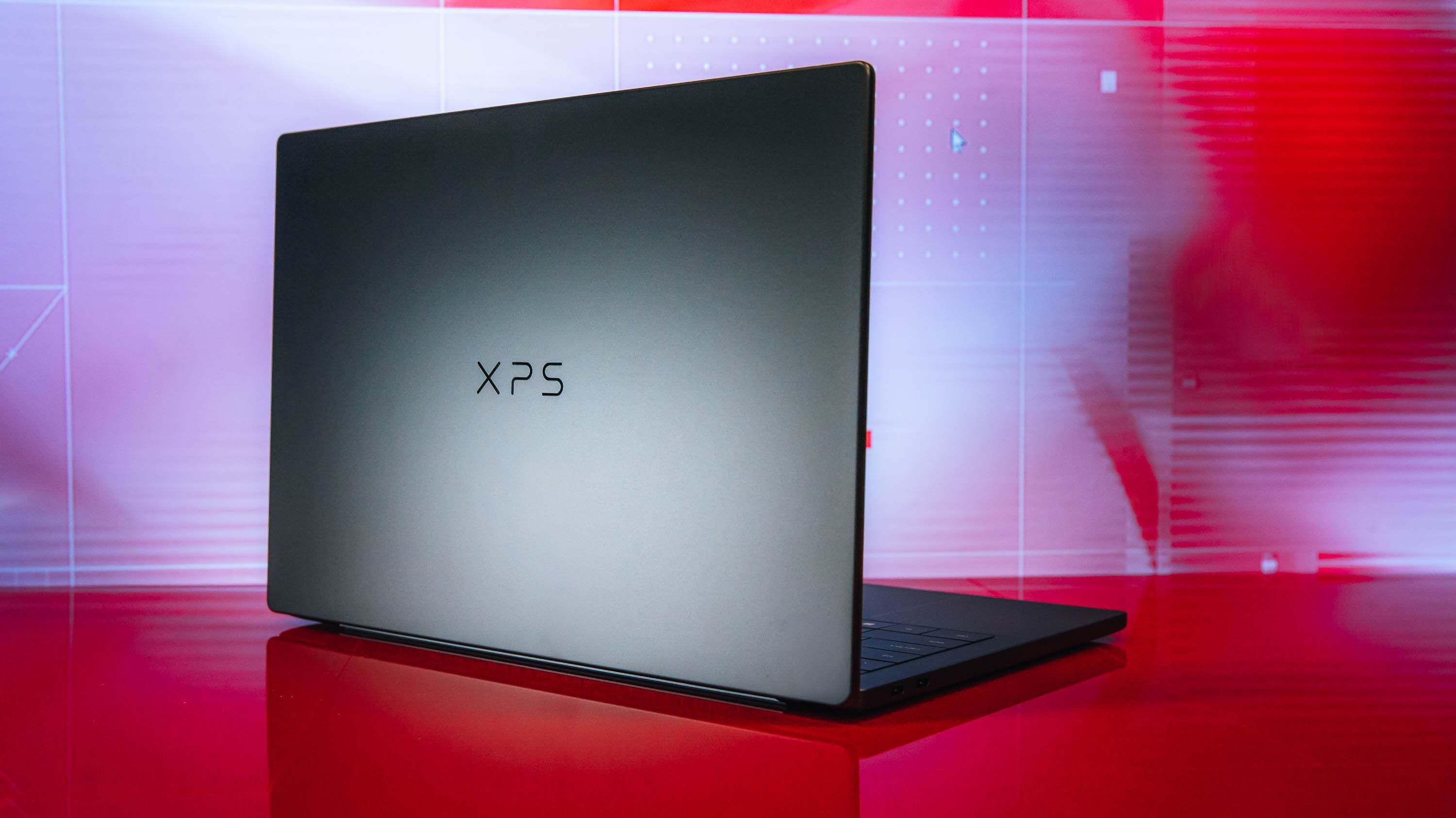 A Dell XPS 14 laptop placed on a clean wooden desk surface.