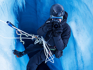 Action photographer capturing high-speed shots in a snowy, extreme winter environment.