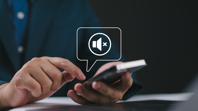 A person placing a finger to their lips in a hushing gesture to indicate quietness.