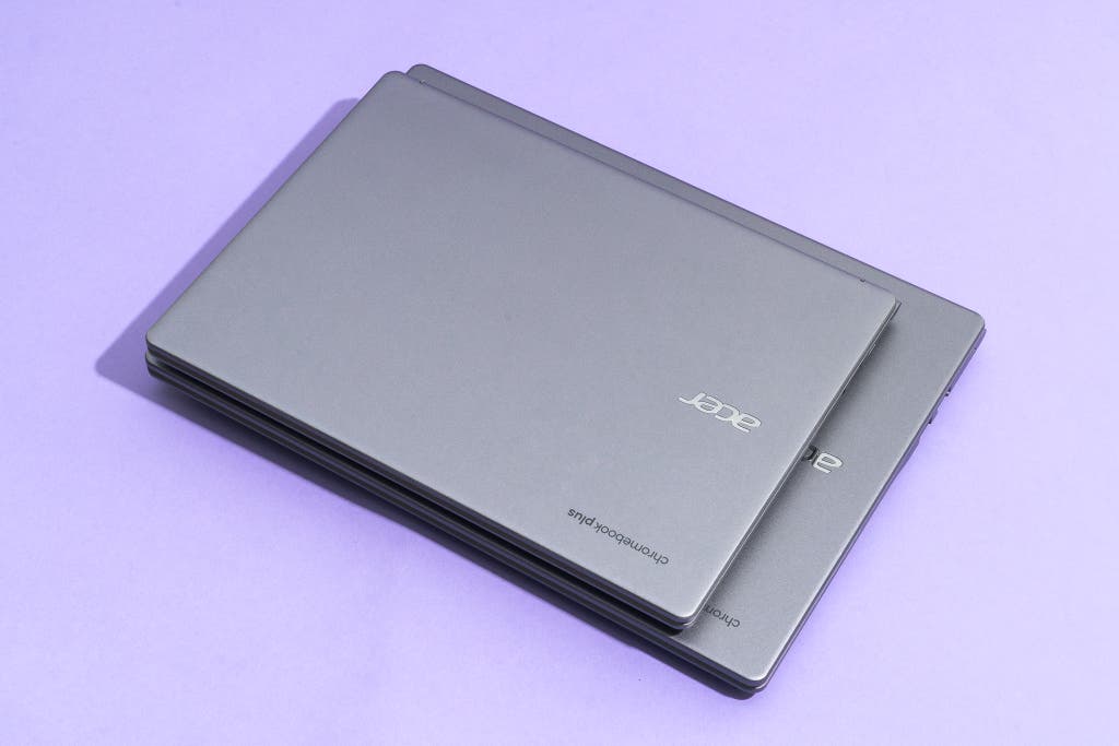 A small 14-inch Chromebook stacked on top of a larger 16-inch model to show size difference.