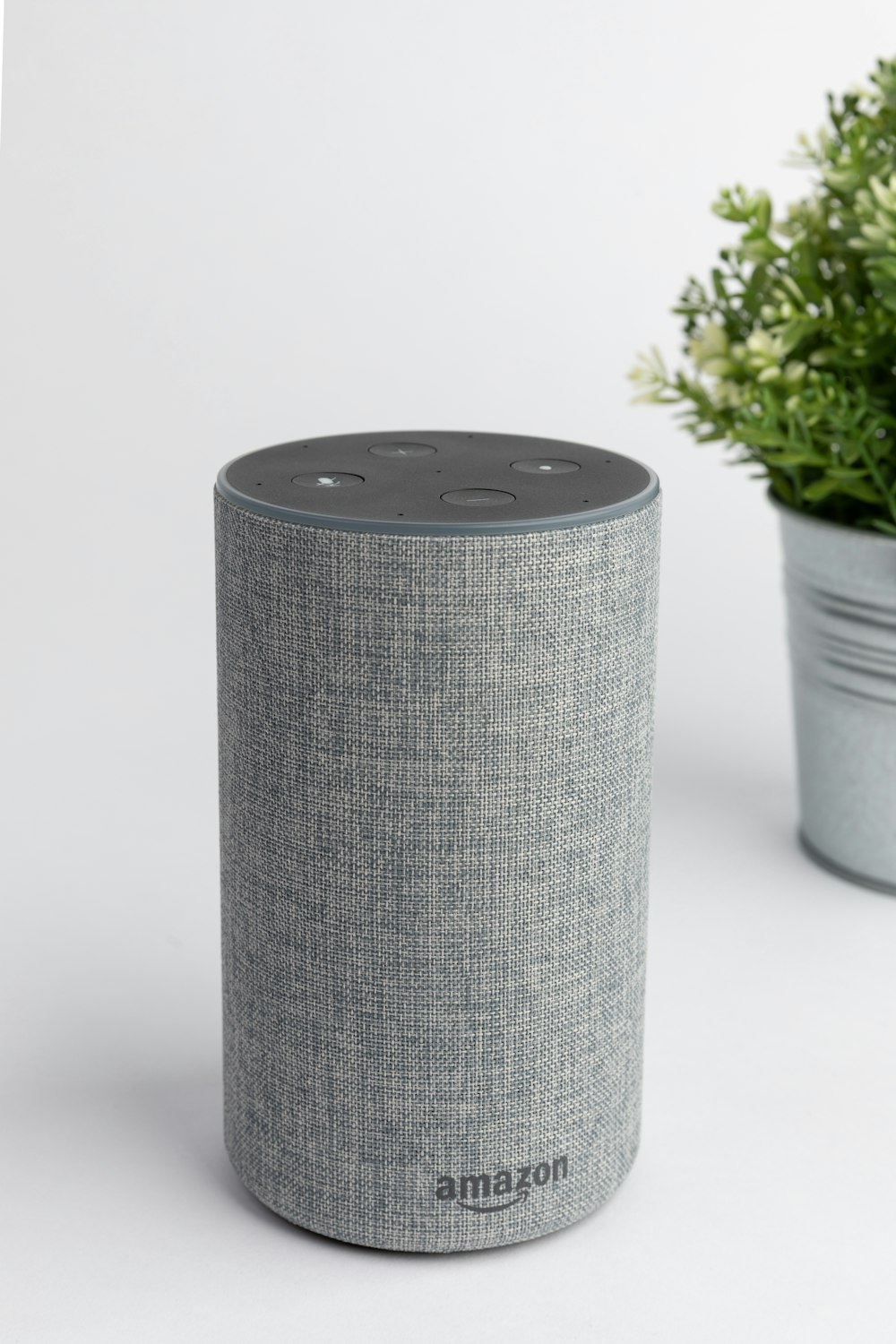A minimalist white smart speaker positioned in a clean, modern home interior to represent Wi-Fi audio solutions.