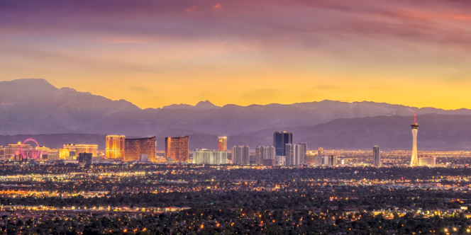 Bright digital displays and crowds moving through the CES campus venues.