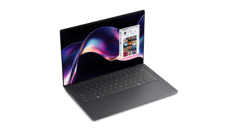 The Dell XPS 14 laptop displayed on a surface highlighting its sleek silver chassis.
