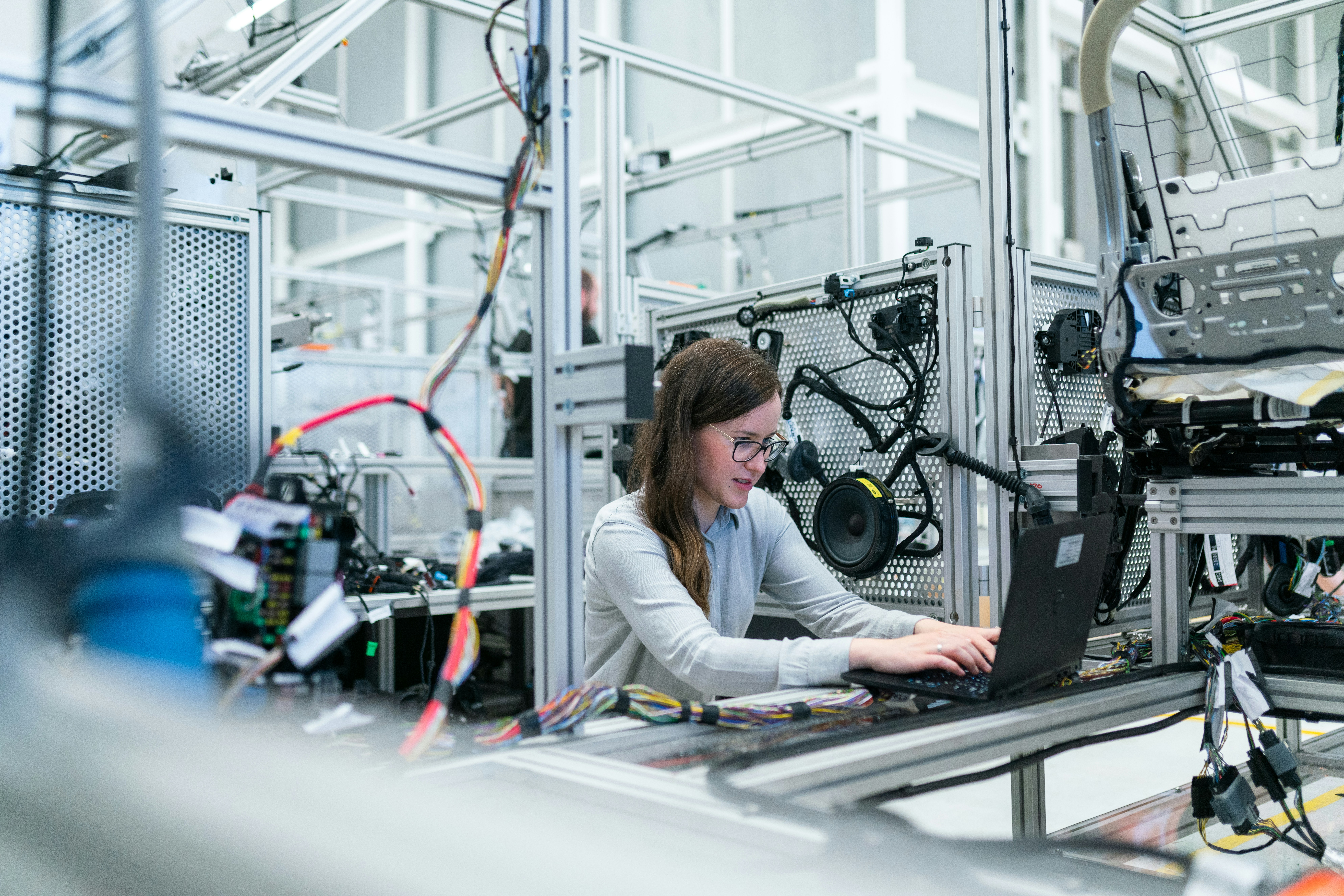 High-tech automated vehicle assembly line with robotic arms in a modern factory.