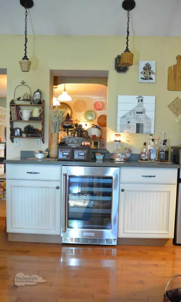A bright modern kitchen with white cabinetry featuring a perfectly integrated counter-depth refrigerator.