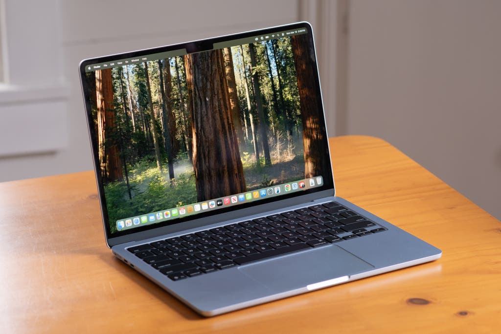 A 13-inch MacBook Air M4 sitting on a wooden countertop in a home office.