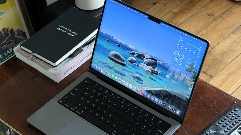 A MacBook Pro running the latest macOS software on a clean office desk.