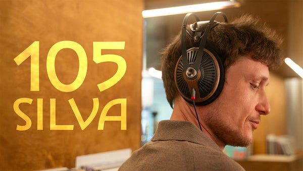 Close-up of premium headphones featuring wooden ear cups and leather headband.