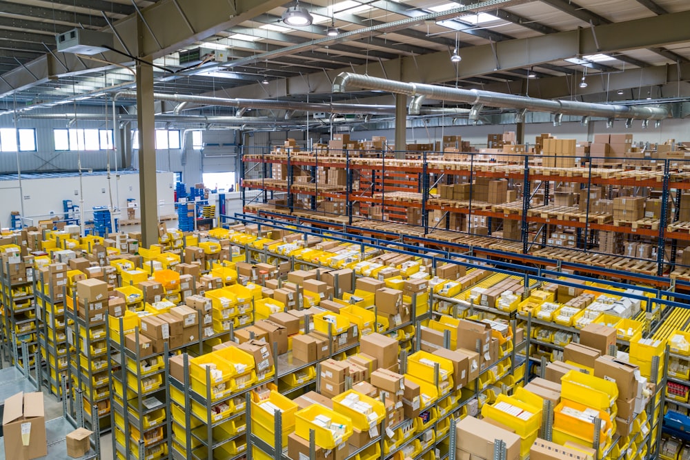 Interior view of a large distribution warehouse with boxes on high shelves.