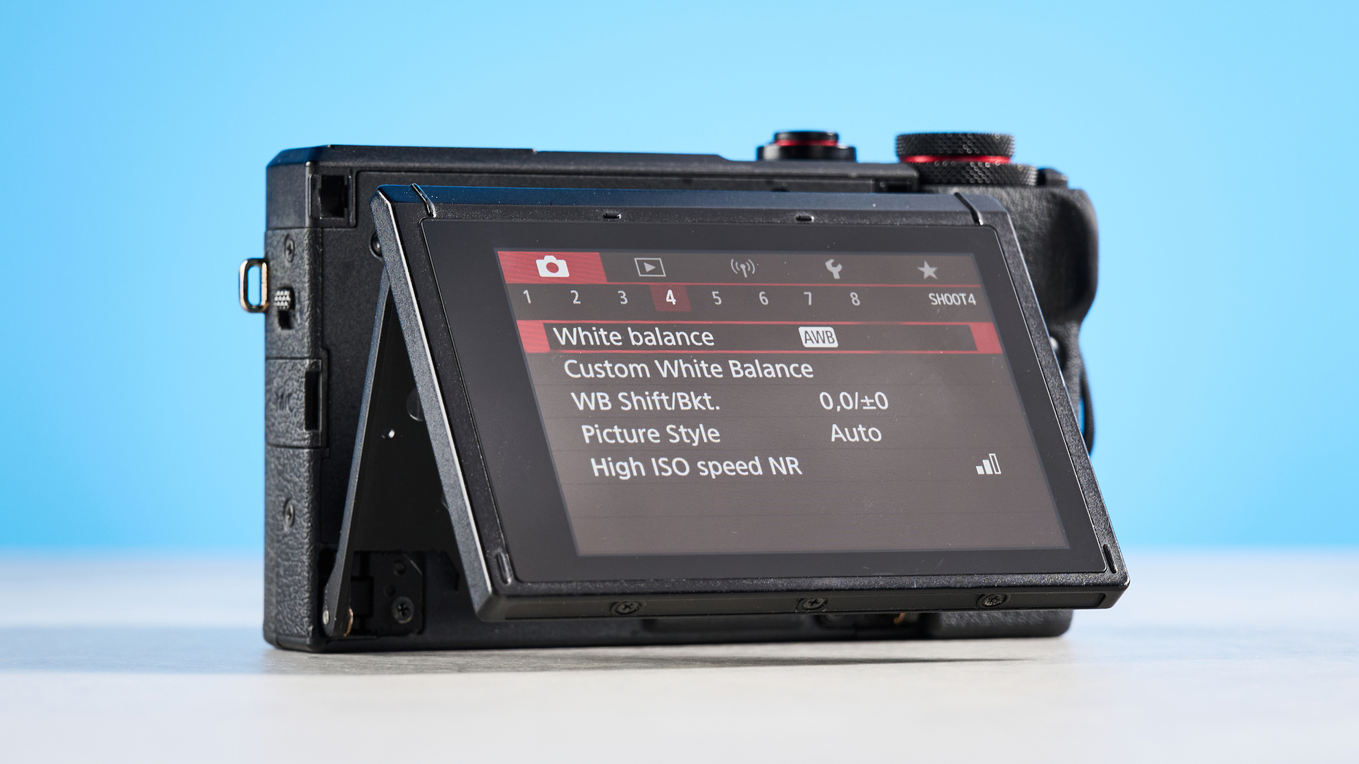 Macro close-up of the Canon 24-100mm f/1.8-2.8 lens and sensor branding.