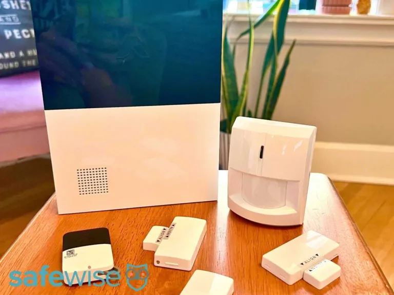 An array of Abode smart security items including a hub, motion sensors, and entry sensors.