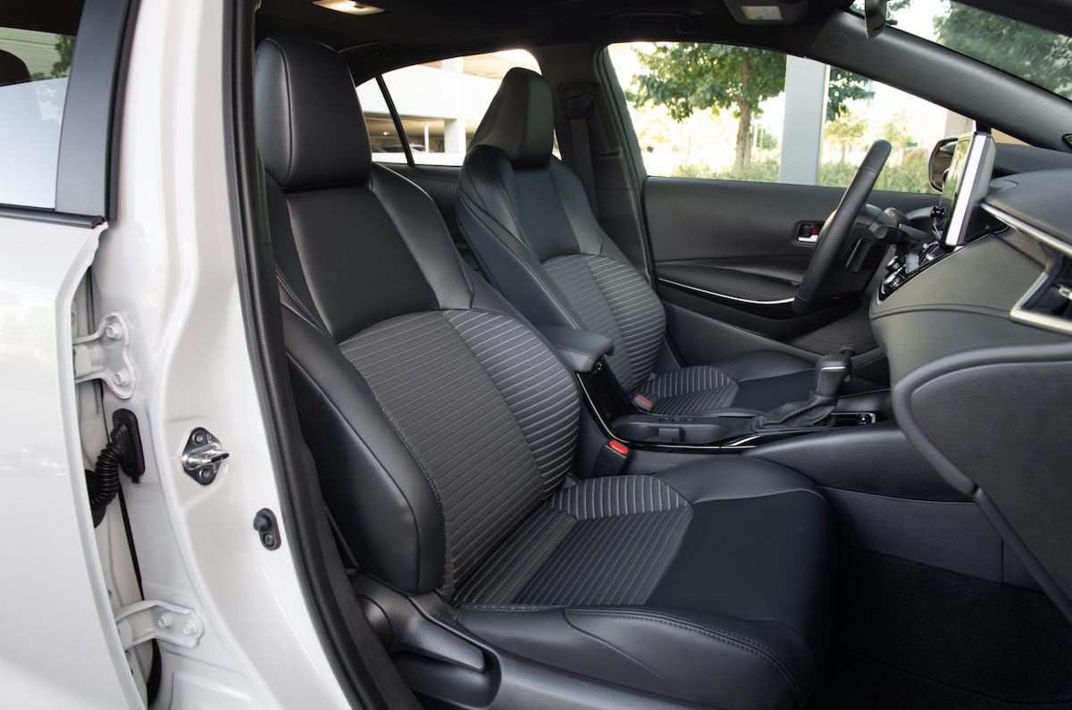Interior shot of the Corolla cabin featuring earth-tone fabrics and modern seat designs.