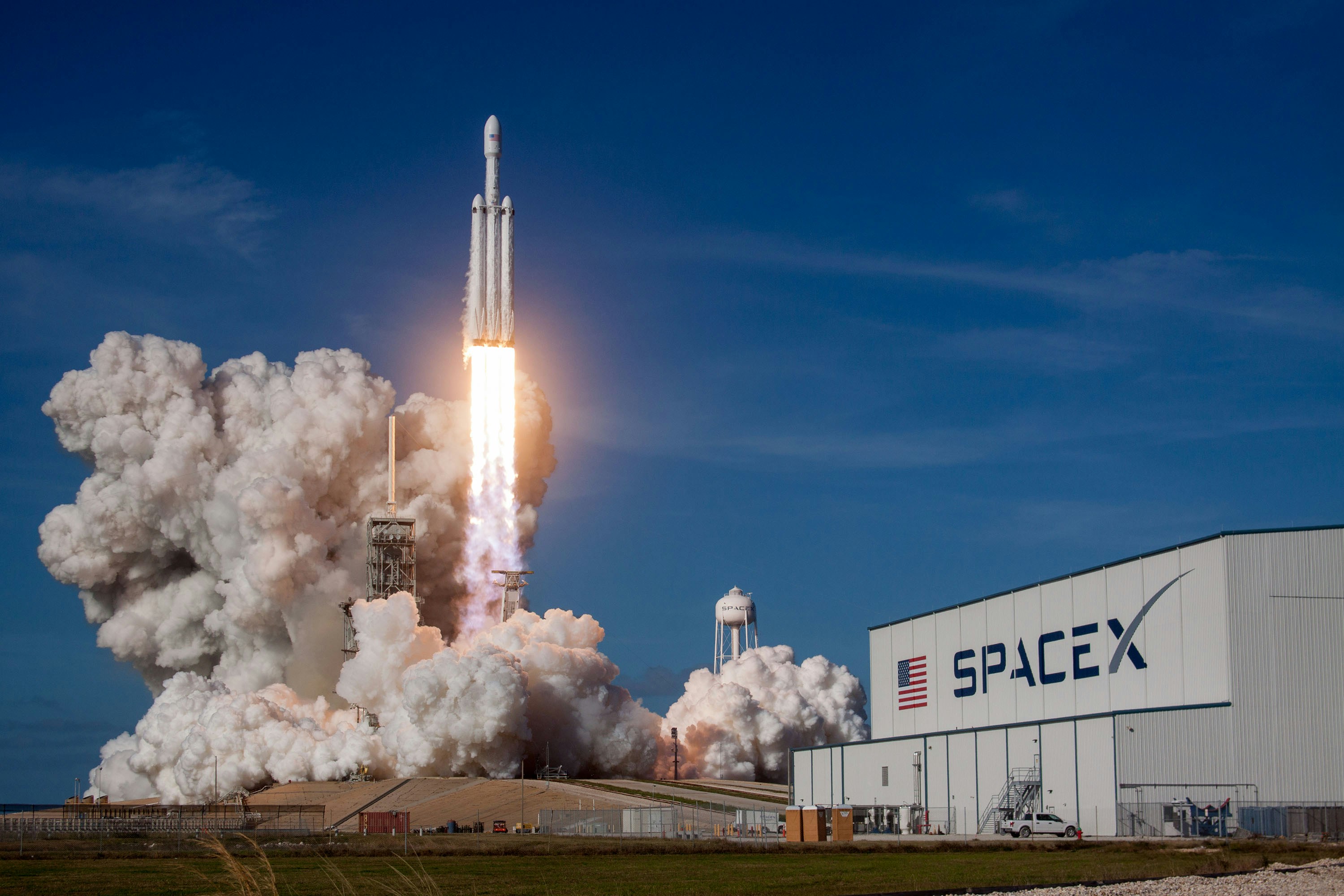 A SpaceX Falcon 9 rocket ascending into the sky carrying Starlink satellites.