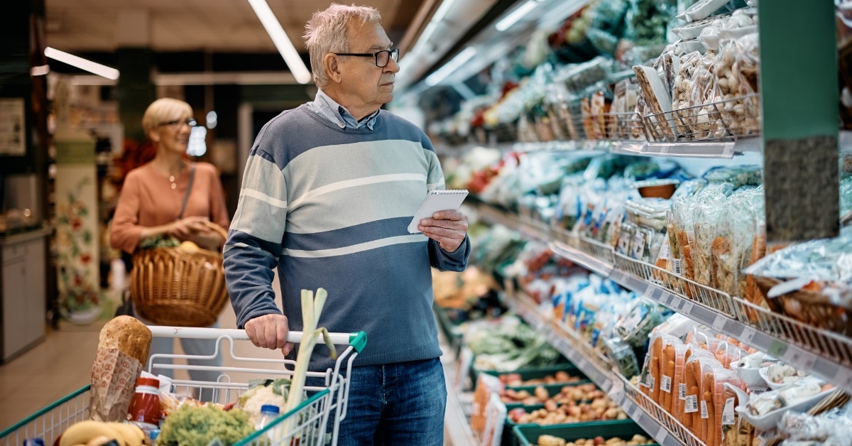 A shopper in a warehouse market aisle.