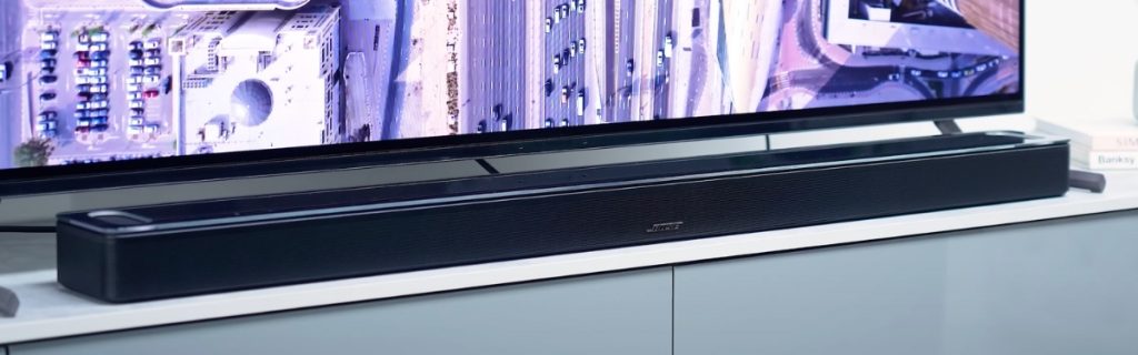 Close-up of the Bose Smart Ultra Soundbar tucked beneath a television screen.